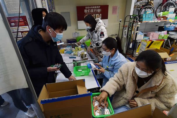 PHOTO: Customers buy medicine at a pharmacy as the local government distributes more fever medicines to the market, following the coronavirus disease (COVID-19) outbreak, in Nanjing, Jiangsu province, China, Dec. 19, 2022. (China Daily/VIA Reuters)