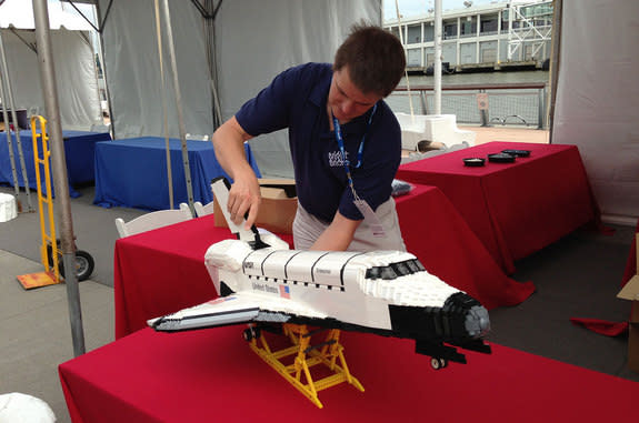 LEGO "Master Builder" Ed Diment attaches the tail to his LEGO model of space shuttle Enterprise before its debut at the Intrepid Sea, Air and Space Museum in New York, July 26, 2013.