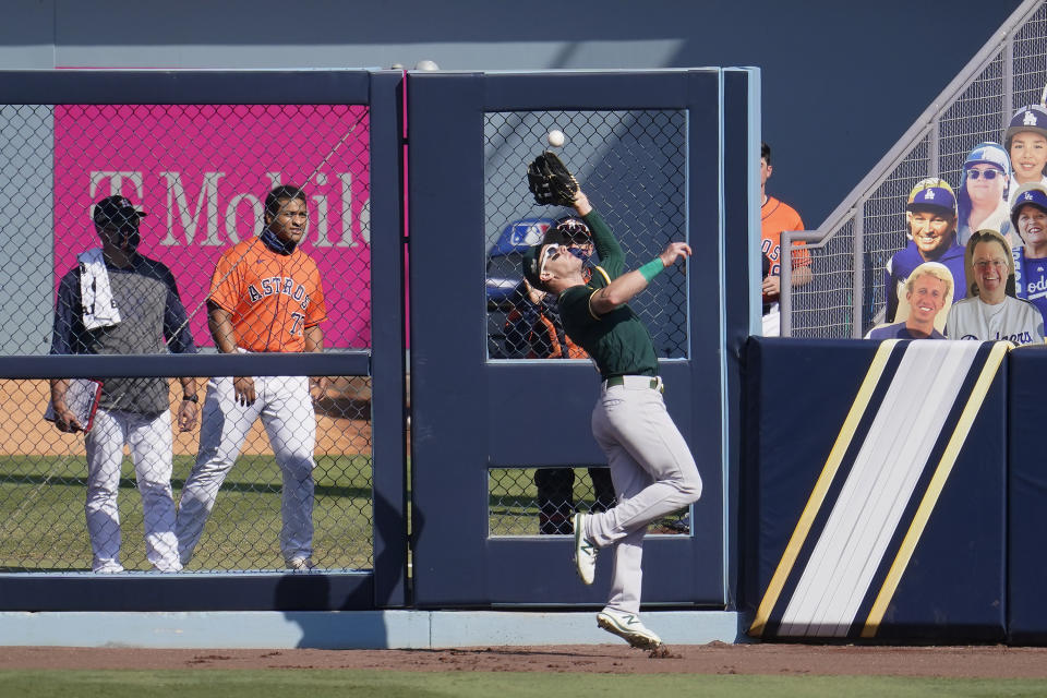 Oakland Athletics right fielder Mark Canha catches Houston Astros' Aledmys Diaz's fly out during the sixth inning of Game 3 of a baseball American League Division Series in Los Angeles, Wednesday, Oct. 7, 2020. (AP Photo/Marcio Jose Sanchez)