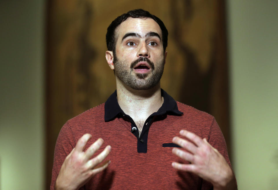 Wes Enos speaks to reporters before the start of a Stonewall 50 event at the New-York Historical Society in New York, Sunday, June 2, 2019. Enos works to share LGBT life stories through the Generations Project, an organization he founded after recognizing many of his peers knew little about their elders. (AP Photo/Seth Wenig)