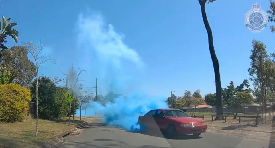 Queensland Police have released dash-camera footage of a red Holden Commodore VP conducting a gender reveal as part of the investigation into the dangerous operation of a vehicle at Logan on Saturday. Source: Queensland Police 