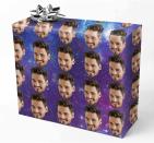 <p>The <span> Custom Photo Wrapping Paper Roll</span> ($16) let's you put your face or the recipients face on the wrapping paper for a hilarious touch. You can choose your bacground, like a galaxy and a variety of festive patterns.</p>