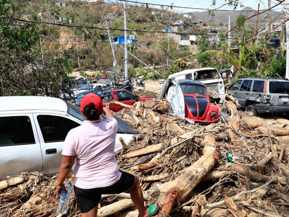 Damaged vehicles and downed trees in Acapulco after Hurricane Otis slammed into the coastal city last week (EPA)