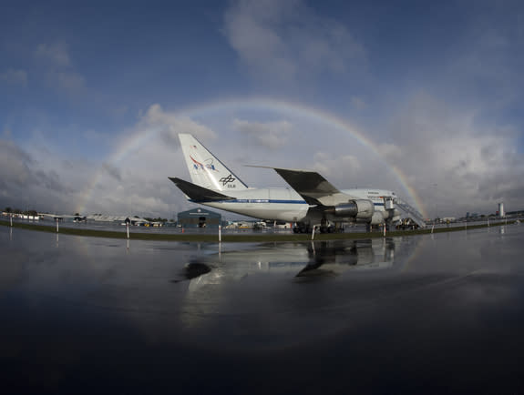 NASA's SOFIA flying observatory is framed by a rainbow following a shower as it sits on a ramp at Christchurch International Airport, New Zealand during its first Southern Hemisphere deployment. This image was released July 18, 2013.