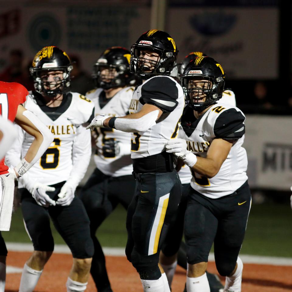 Ashton Sensibaugh is met by teammates after scoring the go-ahead touchdown in the second quarter of Tri-Valley's 28-17 win against host Sheridan on Friday night at Paul Culver Jr. Stadium.