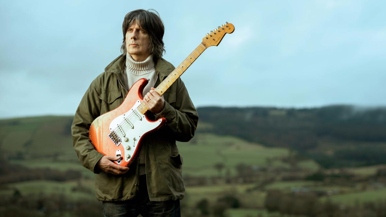  John Squire holding his 2012 Custom Shop Fender Strat. 