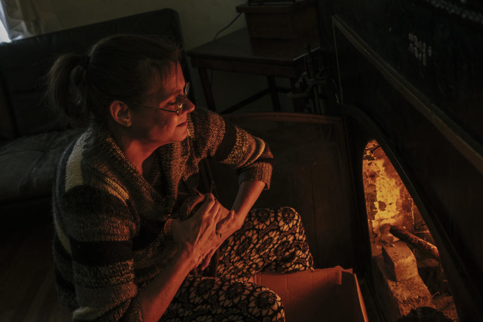 Fritz builds a fire using wood collected from the alley to heat her house. (Photo: Sean Proctor for HuffPost)