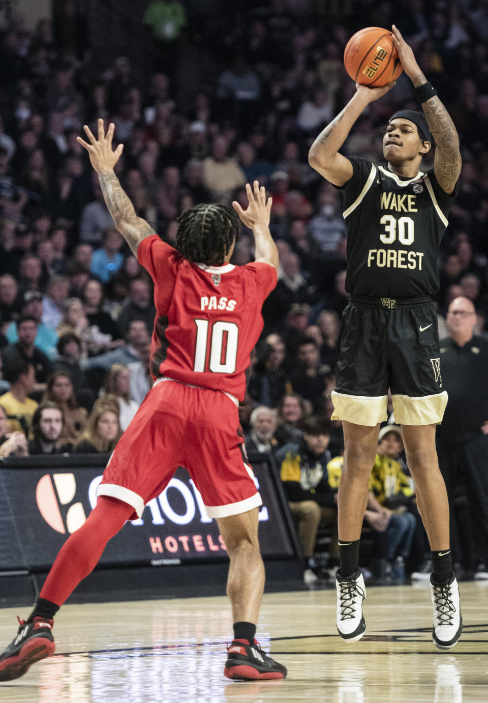 Wake Forest guard Damari Monsanto (30) shoots over North Carolina State guard Breon Pass (10) in the first half of an NCAA college basketball game on Saturday, Jan. 28, 2023, at Joel Coliseum in Winston-Salem, N.C. (Allison Lee Isley/The Winston-Salem Journal via AP)