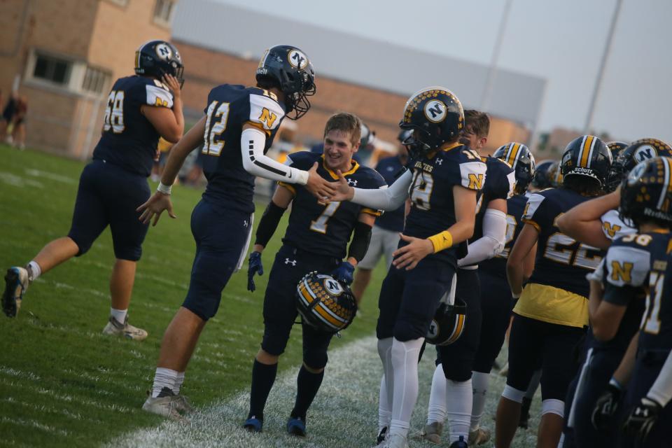 Port Huron Northern players celebrate after scoring a touchdown during the Huskies' 43-8 win over Sterling Heights at Memorial Stadium in Port Huron on Friday.