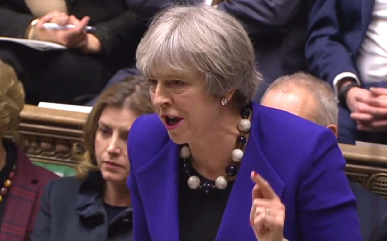 Theresa May speaking during the weekly Prime Ministers Questions (PMQs) session in the House of Commons - AFP