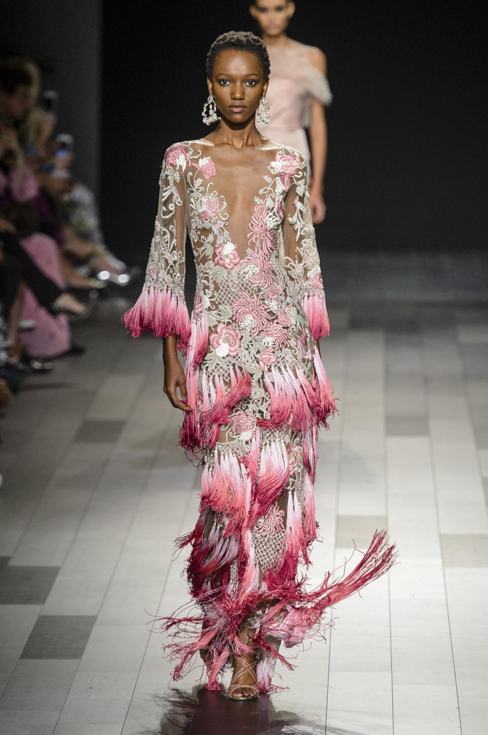 <p><i>Model wears rose-embellished and fringed dress from the SS18 Marchesa collection. (Photo: ImaxTree) </i></p>