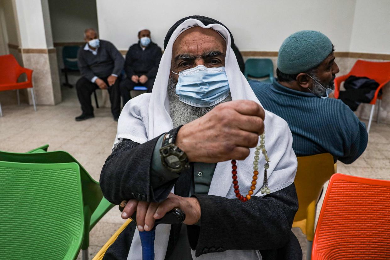 An elderly Palestinian waits to receive a dose of COVID-19 coronavirus vaccine at a clinic in Gaza City (AFP via Getty Images)