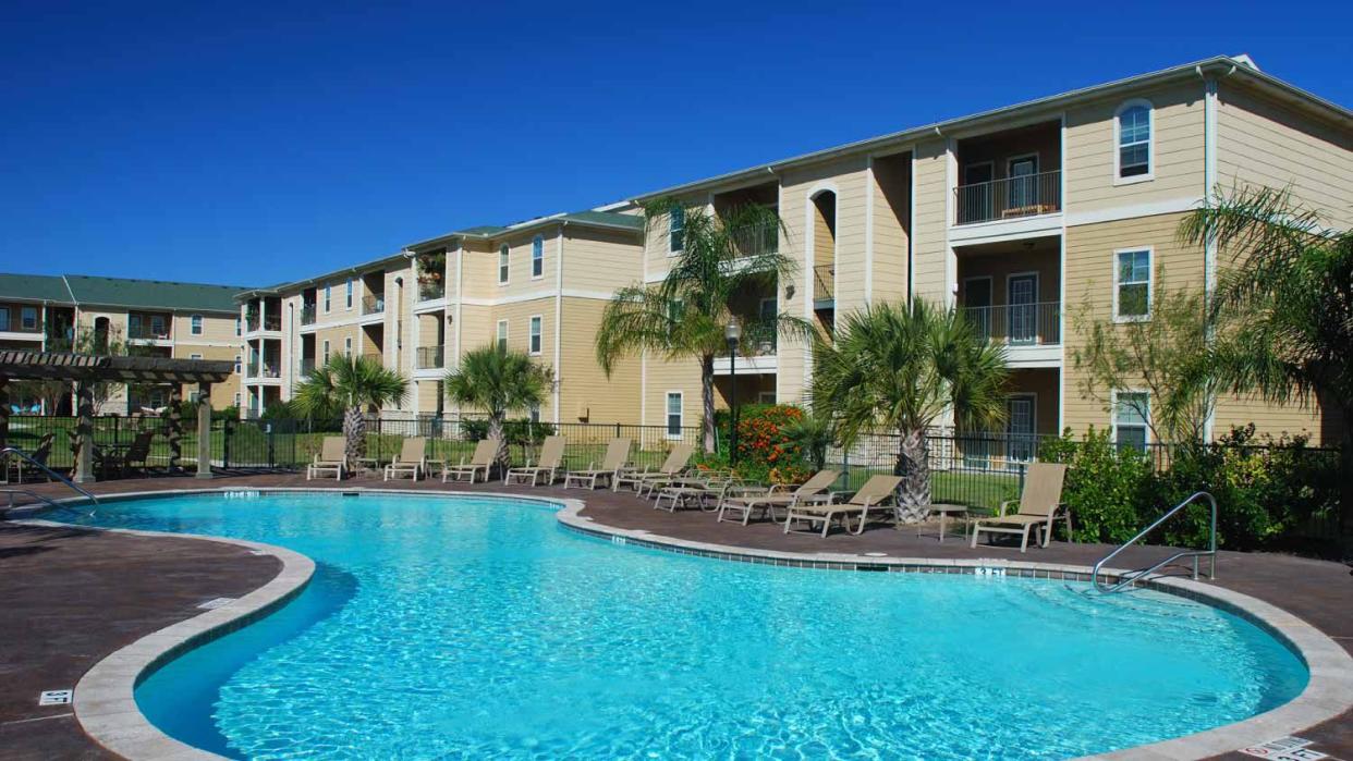 Apartment building with large round pool