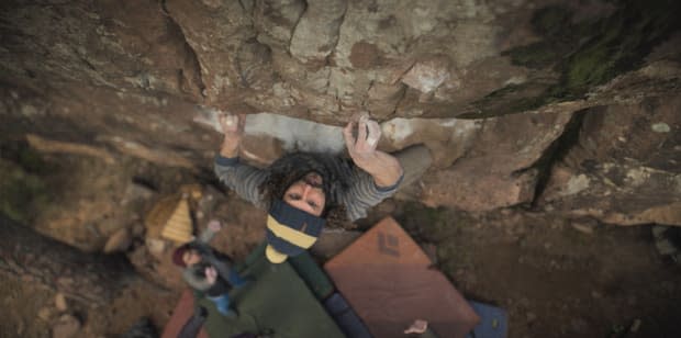 A shot from above of a contestant (Decco) hanging onto the wall of a cliff <em>on the HBO Max series "The Climb"</em><p>HBO Max</p>