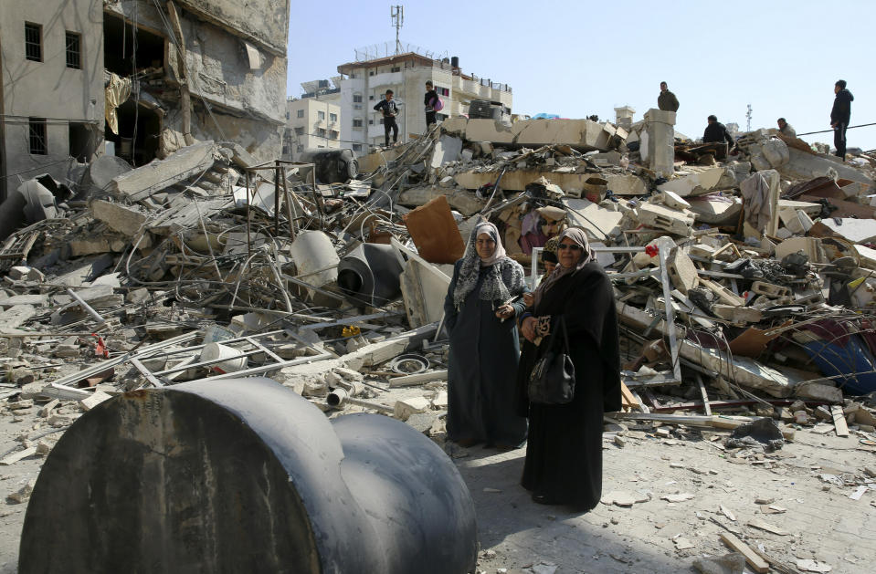 Palestinians search for their family's belongings amid the rubble of destroyed building near a Hamas security building that was destroyed in an Israeli airstrike late Monday, in Gaza City, Wednesday, March 27, 2019. (AP Photo/Adel Hana)