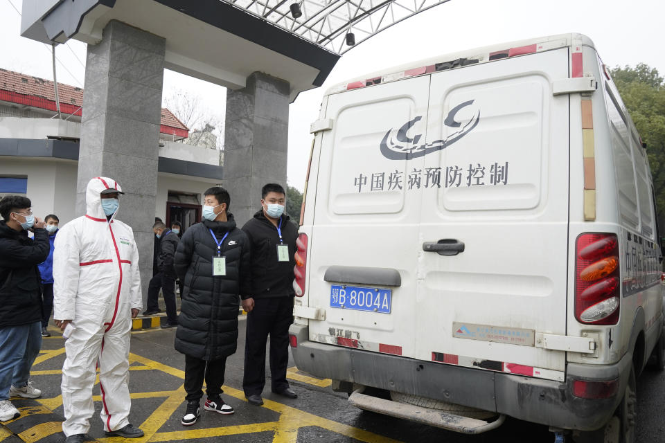 A van from the Hubei Center for Disease Control and Prevention enters the compound as the World Health Organization team makes a field visit in Wuhan in central China's Hubei province on Monday, Feb. 1, 2021. A World Health Organization team investigating the origins of the coronavirus pandemic visited a provincial disease control center that had an early hand in managing the outbreak. (AP Photo/Ng Han Guan)