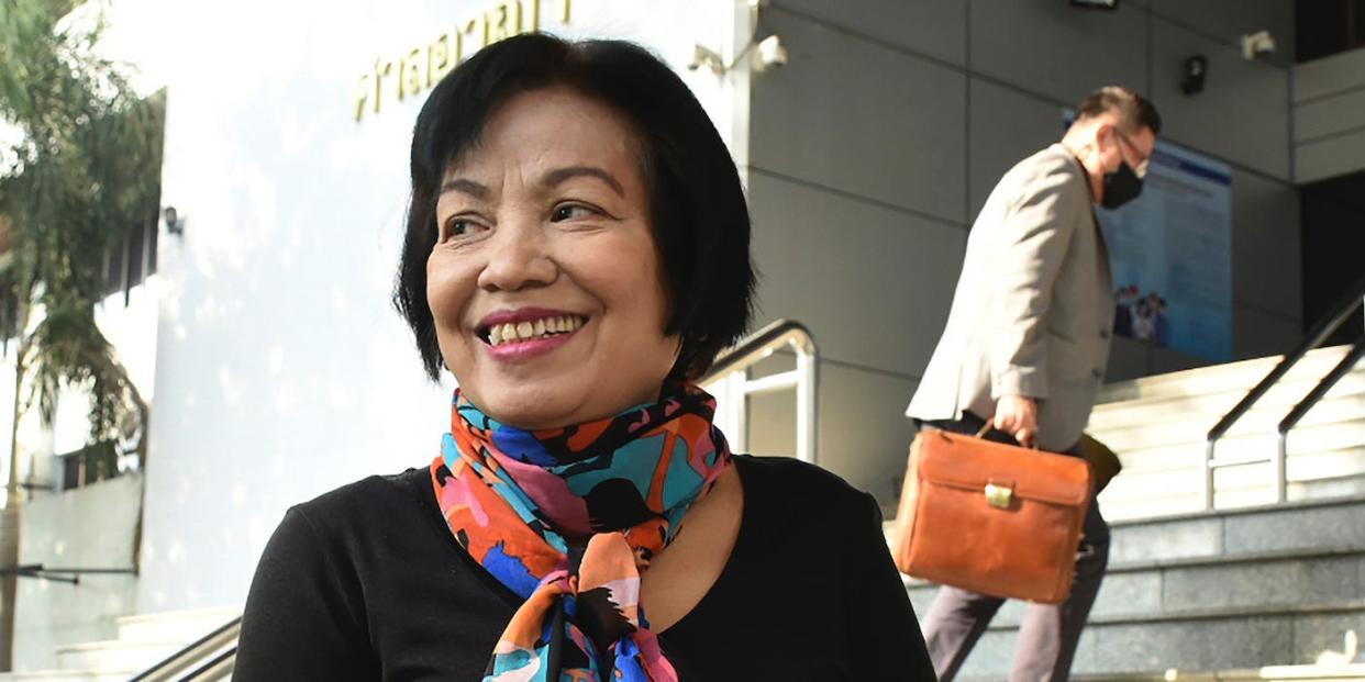 A woman identified only by her first name Anchan, right, talks to her friend as she arrives at the Bangkok Criminal Court in Bangkok, Thailand, Tuesday, Jan. 19, 2021. A court in Thailand on Tuesday sentenced the retired civil servant to a record 43.5 years in prison for insulting the monarchy by posting audio clips online of comments critical of the royal institution.