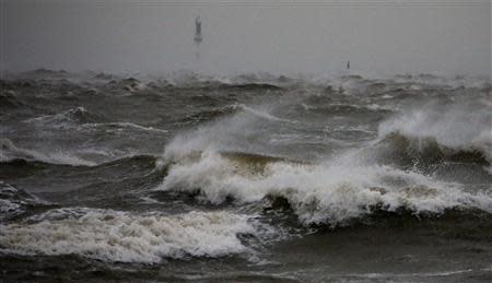 Waves at the North Sea are pictured at a quay wall in Cuxhaven, December 5, 2013. REUTERS/Fabrizio Bensch