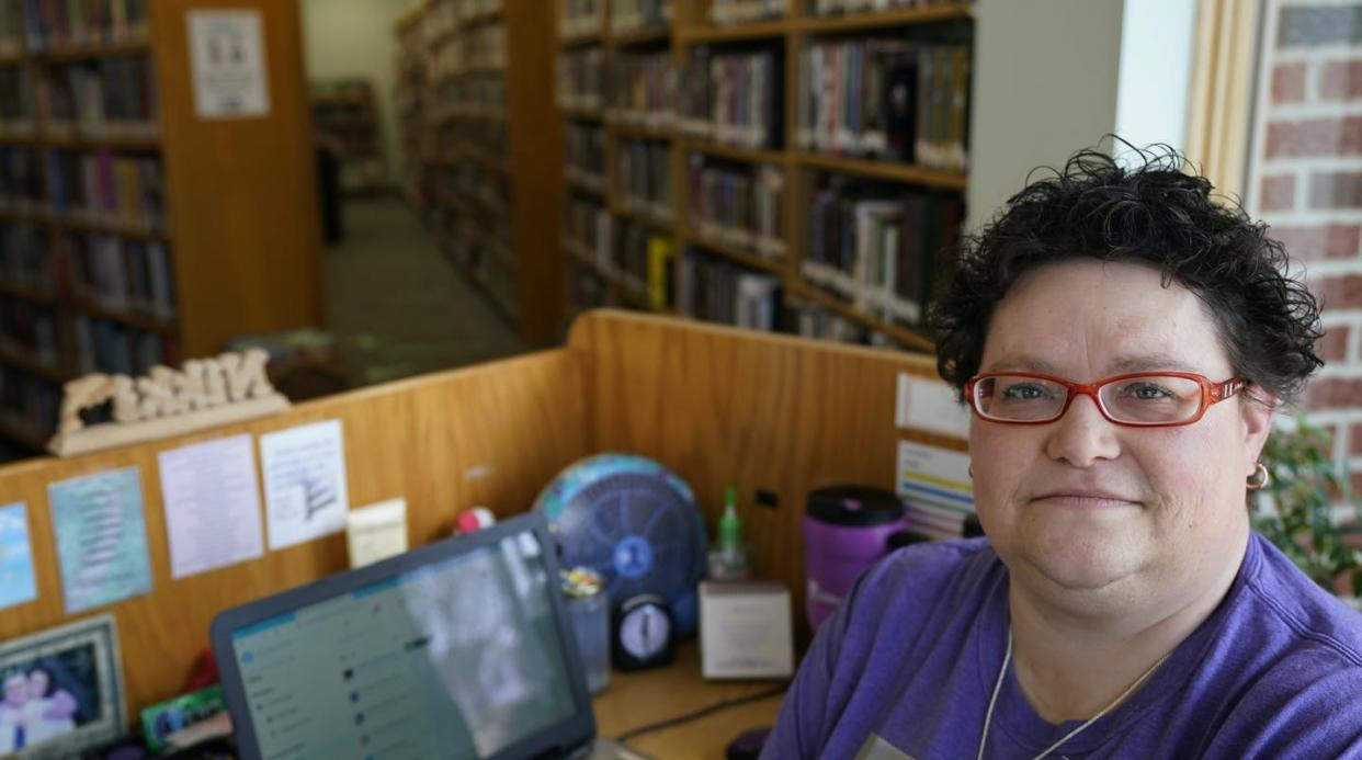 <span class="caption">Nikki Luman works part-time for a public library in Sycamore, Ohio. </span> <span class="attribution"><a class="link " href="https://newsroom.ap.org/detail/VirusOutbreakOneYearAPPollPersonalFinance/de38fd7164bc401089e169c59b480559/photo?Query=libraries%20AND%20pandemic&mediaType=photo&sortBy=arrivaldatetime:desc&dateRange=Anytime&totalCount=58&currentItemNo=3" rel="nofollow noopener" target="_blank" data-ylk="slk:AP Photo/Tony Dejak;elm:context_link;itc:0;sec:content-canvas">AP Photo/Tony Dejak</a></span>