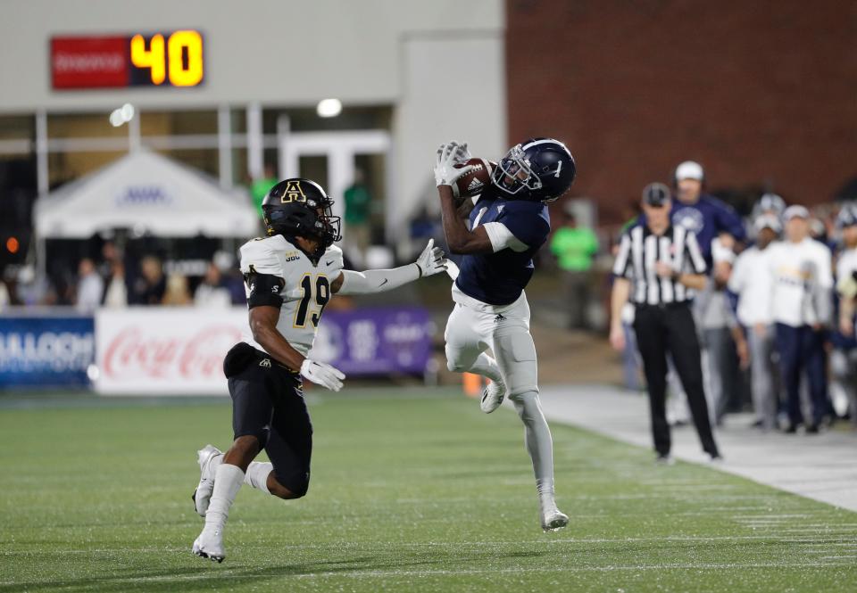 Georgia Southern receiver Jeremy Singleton hauls in a first-down catch in front of Appalachian State's Ethan Johnson during Saturday night's game at Paulson Stadium.