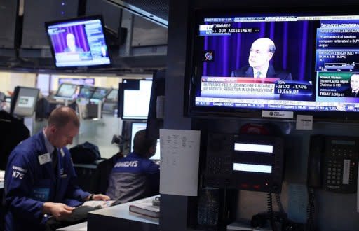 Fed Chairman Ben Bernanke is seen on screens on the floor of the New York Stock Exchange as he speaks at a news conference on September 13, in New York City. The US Federal Reserve took aim at slow growth and high joblessness, announcing a new, open-ended $40 billion per month bond-buying program as it slashed its 2012 growth forecast