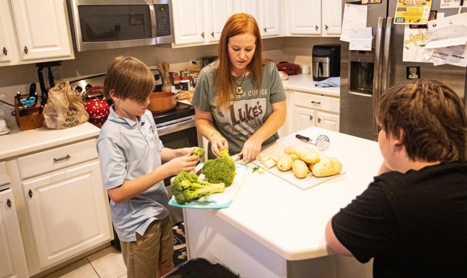 Stephanie Nordin makes dinner with her sons, Eli and Titus at their Naples home on Monday, April 15, 2024. The mother of four has become successful at champion-ing some legislation for the state to protect children with autism(1,900 kids in Collier are on then spectrum) and some changes to local parks as well. Her twins, (not pictured) Logan and Gavin,14, have autism.