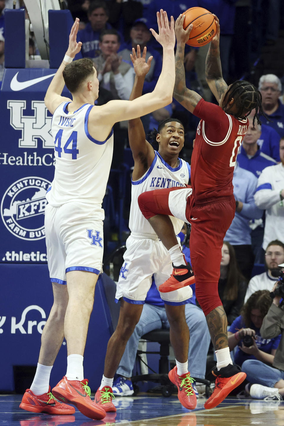 Kentucky's Zvonimir Ivisic (44) and Rob Dillingham, middle, defend Arkansas' Khalif Battle, right, during the second half of an NCAA college basketball game Saturday, March 2, 2024, in Lexington, Ky. Kentucky won 111-102.(AP Photo/James Crisp)