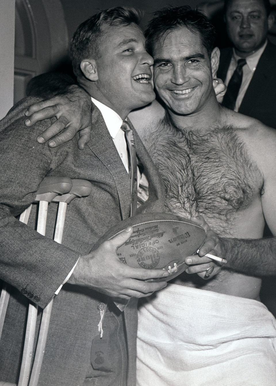 Detroit Lions quarterback Bobby Layne, left, who broke his ankle prior to the game, hugs quarterback Tobin Rote after the Lions beat the San Francisco 49ers in the Western Conference championship in this Dec. 22, 1957 file photo in San Francisco. Detroit went on to beat the Cleveland Browns in the NFL Championship, at Tiger Stadium.