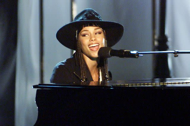 <p>Kevin Winter/Getty</p> Alicia Keys performing in Santa Monica in August 2001