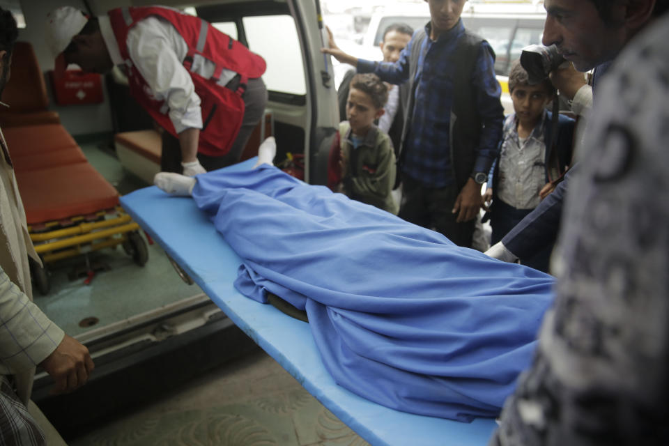 FILE - In this April 7, 2019 file photo, Yemenis carry the body of a girl who was killed in an explosion at a warehouse that killed at least seven children in nearby schools, at a hospital in Sanaa, Yemen. The United Nations said Tuesday, Oct. 19, 2021 that more than 10,000 children in Yemen have now been killed or injured in violence linked to years of war in the impoverished country. The children’s agency UNICEF said the verified tally is surely an undercount of the real toll. (AP Photo/Hani Mohammed, File)