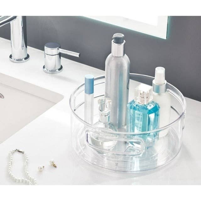 clear rotating organizer on bathroom counter