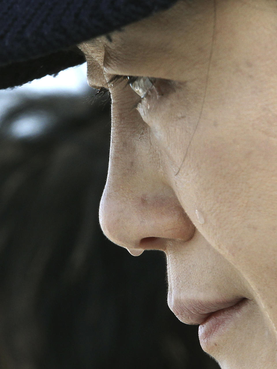 A relative of a passenger aboard the sunken ferry Sewol weeps as she waits for her missing loved one at a port in Jindo, South Korea, Monday, April 21, 2014. Divers continued the grim work of recovering bodies from inside the sunken South Korean ferry Monday, securing a new entryway into the wreck, as a newly released transcript showed the ship was crippled by confusion and indecision well after it began listing. The transcript suggests that the chaos may have added to a death toll that could eventually exceed 300. (AP Photo/Ahn Young-joon)