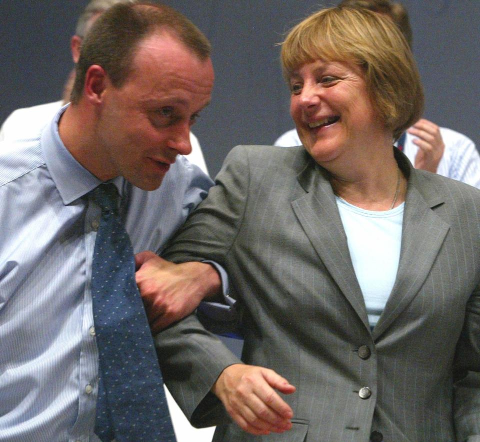 A 2002 file photo shows Merz former parliamentary floor leader of the conservative German Christian Democratic Union joking with CDU leader Angela Merkel after addressing the CDU party convention in Frankfurt.  Friedrich Merz (L), former parliamentary floor leader of the conservative German Christian Democratic Union (CDU) jokes with CDU leader Angela Merkel after addressing the CDU party convention in Frankfurt in this June 18, 2002 file photo. The main CDU finance spokesman Friedrich Merz is planning to step down from the party leadership board. REUTERS/Arnd Wiegmann/File Photo