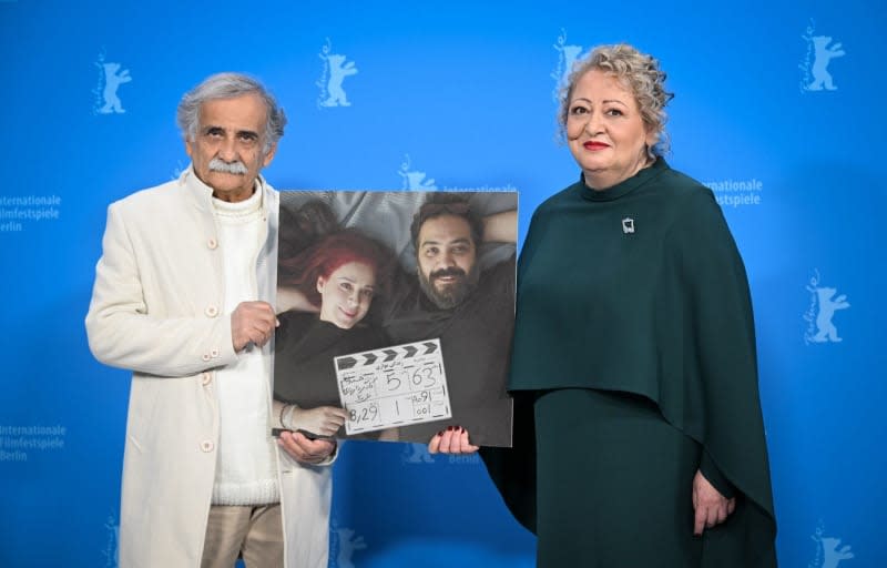 Actors Esmail Mehrabi (L) and Lily Farhadpour hold a photo showing the two directors Maryam Moghaddam (L) and Behtash Sanaeeha during the photocall for the film "Keyke MahBoobe Man" (My Favorite Cake at the 74th Berlin International Film Festival (Berlinale). Soeren Stache/dpa