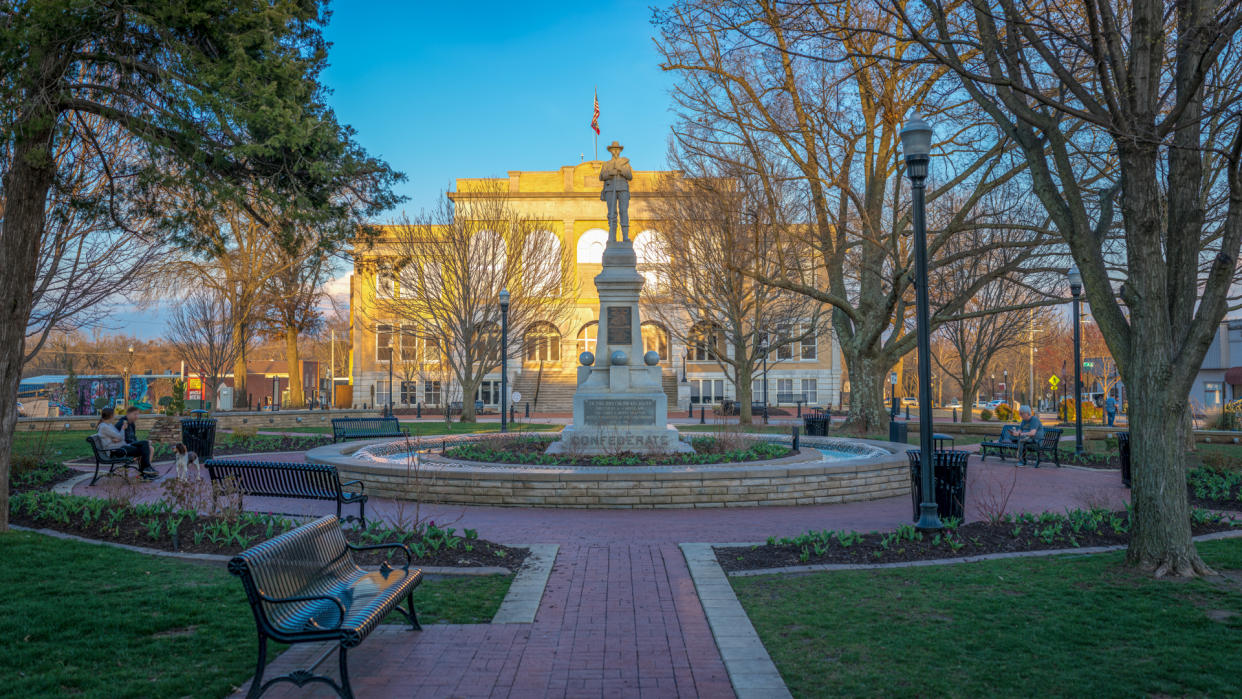 Bentonville, Arkansas / USA - March 24 2019: Sunset over Beautiful Downtown Bentonville Square, Benton County Court House building, Northwest Arkansas, confederate statue.