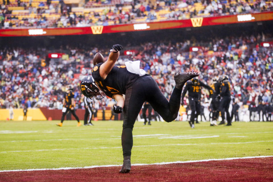 Washington Commanders tight end John Bates (87) celebrates his touchdown catch from quarterback Taylor Heinicke (4) during the second half of a NFL football game between the Atlanta Falcons and the Washington Commanders on Sunday, Nov. 27, 2022 at FedExField in Landover, Md. (Shaban Athuman/Richmond Times-Dispatch via AP)