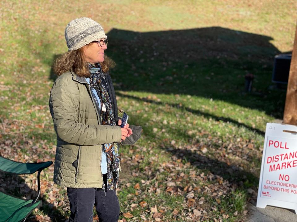 Democratic party volunteer Maria Danges waits outside the polling place at the Heritage Center in Mountain View Park on Nov. 8, 2022.