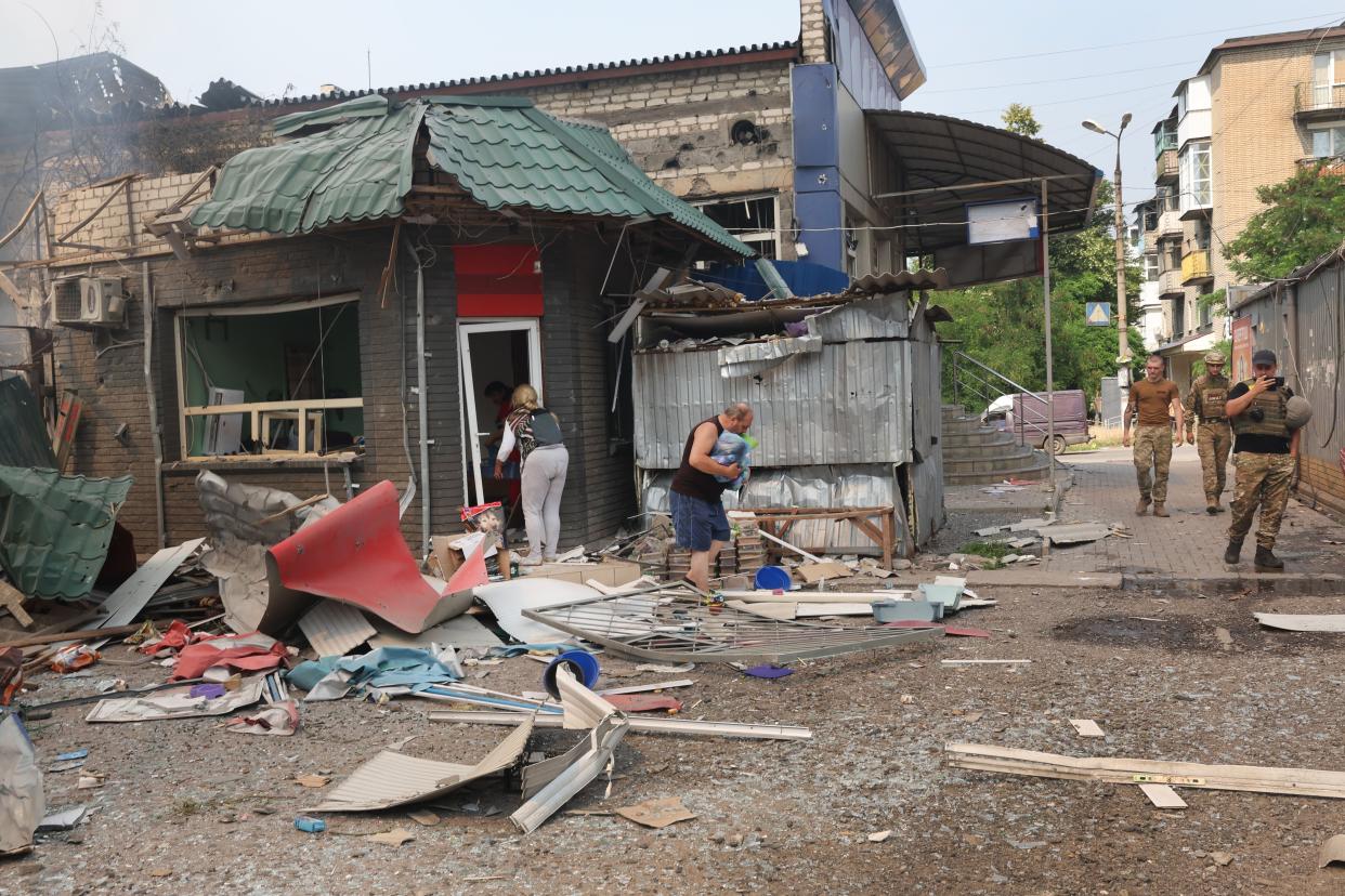 People salvage merchandise from their shops after a missile stuck a shopping mall on July 03, 2022 in Sloviansk, Ukraine. The attack was one of many in the city early Sunday afternoon.