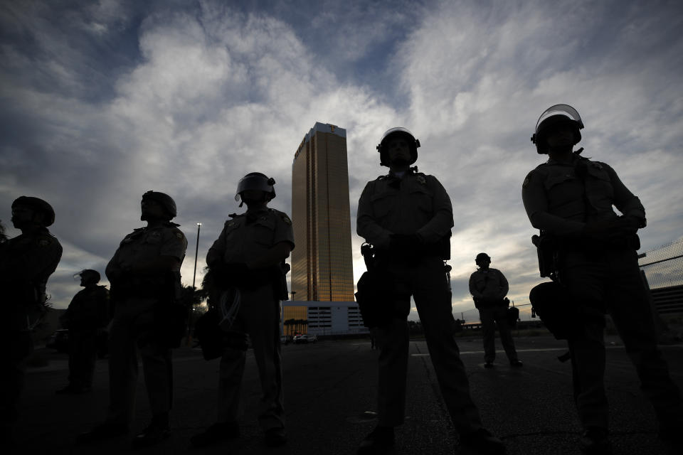 FILE - In this June 1, 2020, file photo police stand guard as protesters rally in Las Vegas. The police killing of George Floyd in Minneapolis has sparked new interest in training officers how to stop colleagues from using excessive force and committing other misconduct. (AP Photo/John Locher)