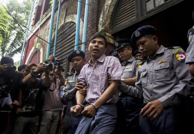 Myanmar journalist Kyaw Soe Oo is escorted out of the court