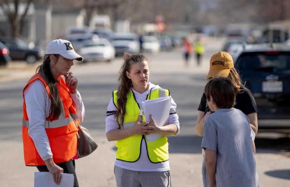 Heather Robker, center, speaks to a boy while canvassing for her missing 13-year-old son, Jayden Robker, in the Lakeview Terrace neighborhood on Sunday, March 5, 2023, in Kansas City. Jayden was last seen Feb. 2 at N.W. Plaza Drive and N.W. Plaza Ave.