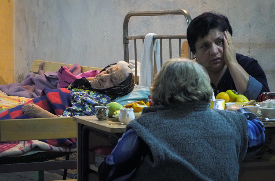 Women take refuge in a bomb shelter in Stepanakert, the separatist region of Nagorno-Karabakh, Tuesday, Nov. 3, 2020. Fighting over the separatist territory of Nagorno-Karabakh entered sixth week on Sunday, with Armenian and Azerbaijani forces blaming each other for new attacks. (AP Photo)