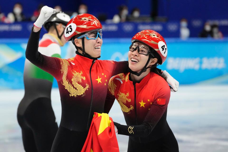 Kexin Fan (left) and Chunyu Qu celebrate winning gold in the mixed team relay final.