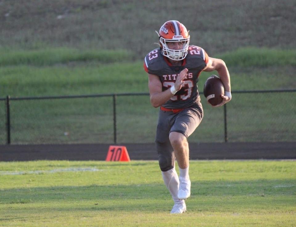 Owen Baylor takes off on a fake punt in the first quarter of University's win over Hagerty, Friday, Aug. 25, 2023.