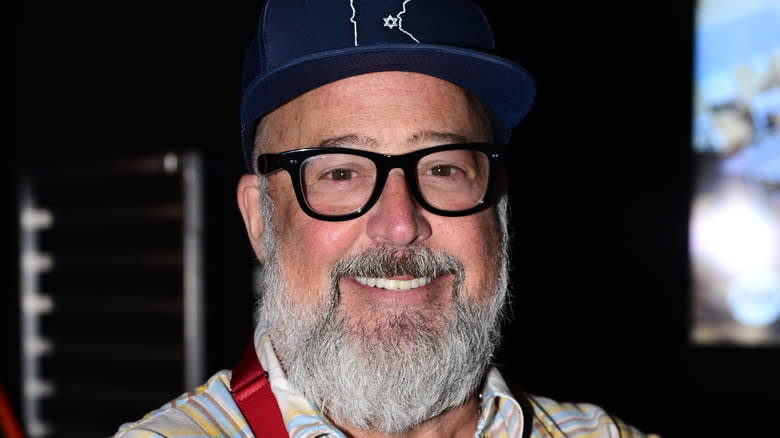 Andrew Zimmern smiling with hat