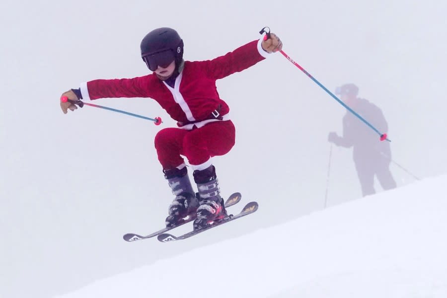 A young skier dressed as Santa Claus catches some air, Sunday, Dec. 10, 2023, at the Sunday River ski resort in Newry, Maine. The annual Santa Sunday event raises money for local charities. (AP Photo/Robert F. Bukaty)