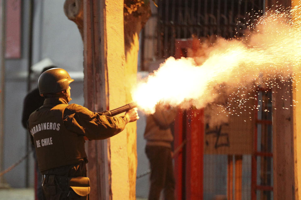 Police fire tear gas at protesters violating a curfew in downtown Santiago, Chile, Sunday, Oct. 20, 2019. Protests in the country have spilled over into a new day, even after President Sebastian Pinera cancelled the subway fare hike that prompted massive and violent demonstrations. (Photo: Esteban Felix/AP)