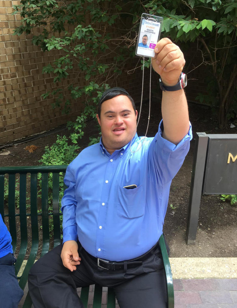 In this photo, date not known, provided by Stephen Glicksman, Saadya Ehrenpreis holds up his Yeshiva University student ID while on campus in New York. (Stephen Glicksman via AP)