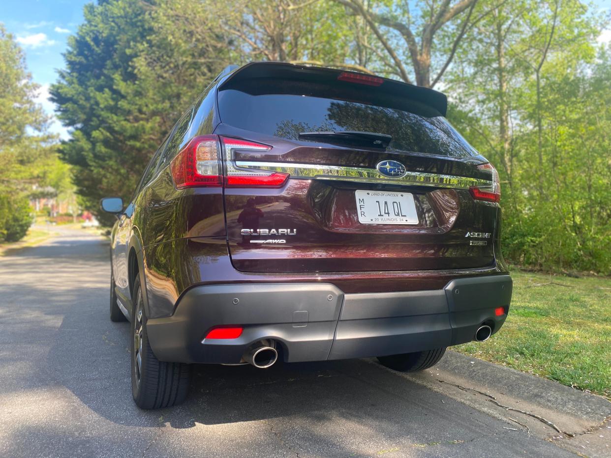 The Subaru Ascent's rear-end design features a large chrome bar across the tail gate and dual exhausts.