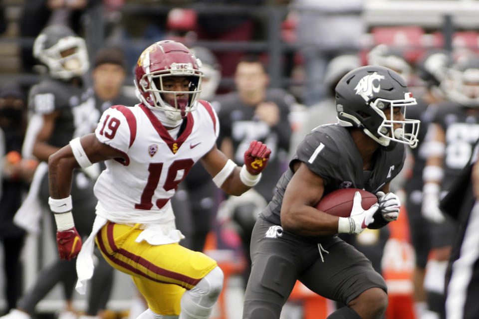 Washington State wide receiver Travell Harris (1) carries the ball while defended by Southern California safety Jaylin Smith (19) during the second half of an NCAA college football game, Saturday, Sept. 18, 2021, in Pullman, Wash. Southern California won 45-14. (AP Photo/Young Kwak)